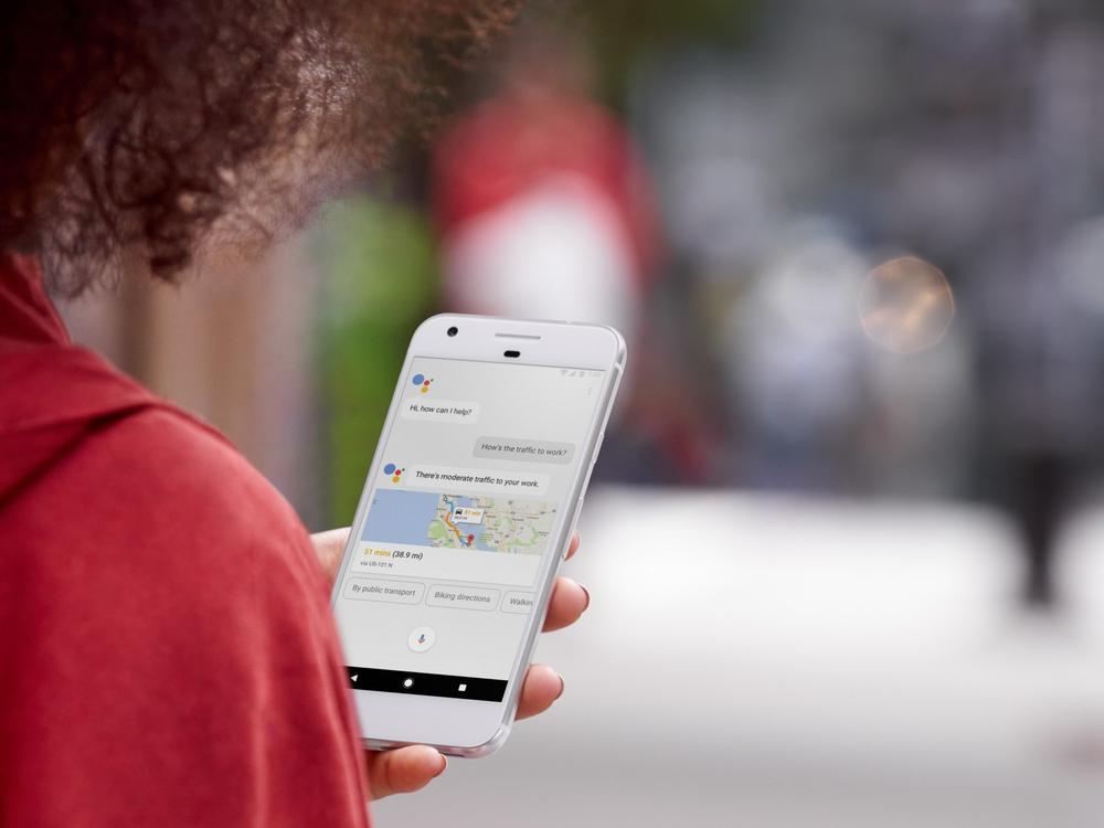 Photograph of a person using Google Assistant on an Android phone to check traffic on their route to work.