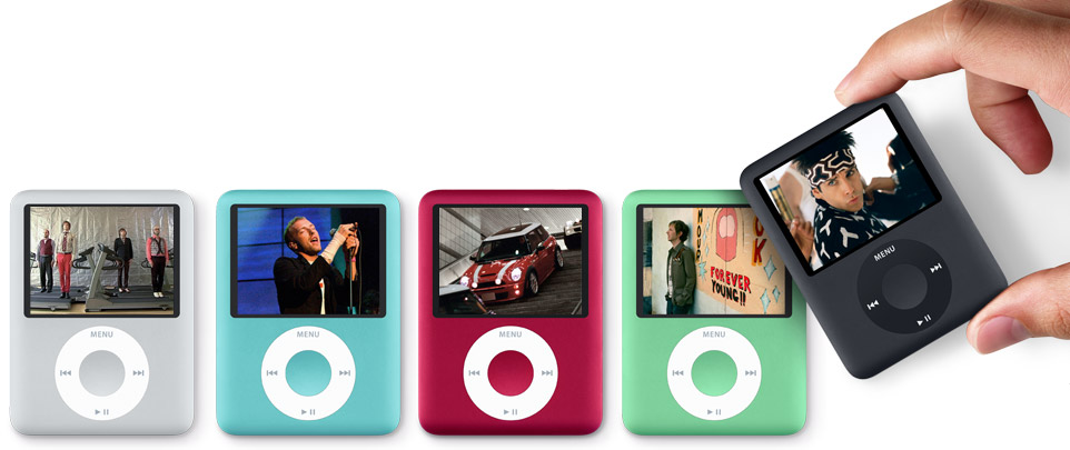 Product promotional shot of five colorful third-generation iPod nanos, each screen showing music videos or movies, with the far-right iPod being picked up by an out-of-frame hand.